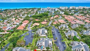 A residential area with houses, a parking lot, and a large hotel in the background. - Beachside townhouse with private office space (Jupiter)