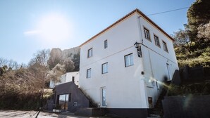 A two-story building with a white facade and a red-tiled roof. - Encosta d Bidos T1 (Obidos)