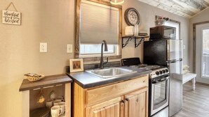 A kitchen with a wooden countertop, stainless steel appliances, and a window with blinds. - Granite Peak. Near Mt-Rushmore National Memorial (Keystone)