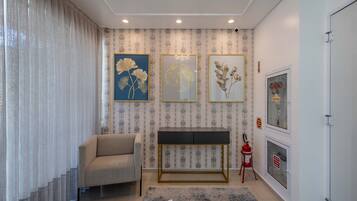 A modern living room with a sofa, a console table, and decorative wall art.