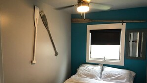 A bedroom with a bed, a window with a white blind, a ceiling fan, and a wall-mounted light fixture. - 2BR Room at Alexander’s Landing. Walk to Indiana Beach + Pool Access (Monticello)
