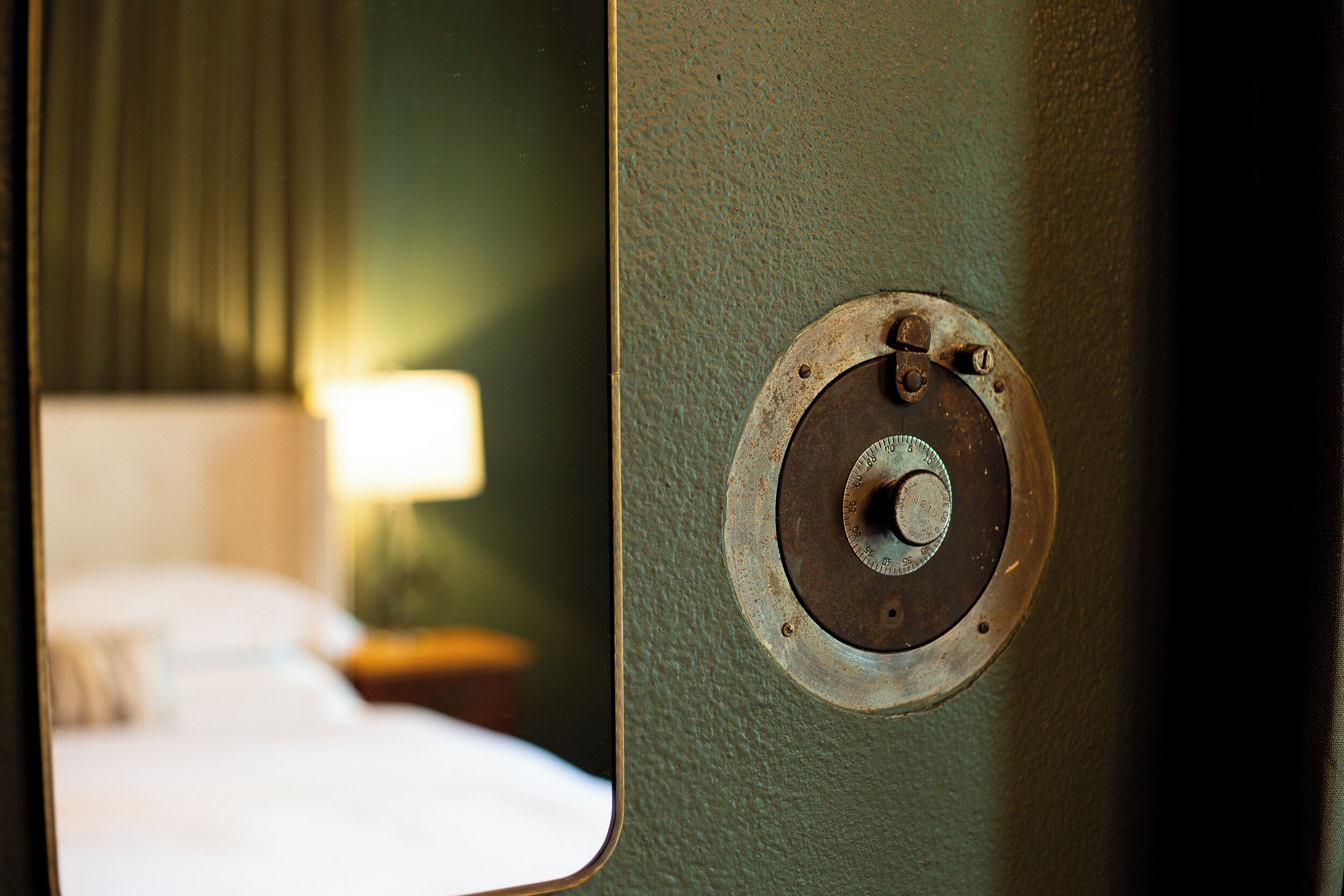 A close-up of a door handle with a circular metal plate, a visible bolt, and a keyhole.