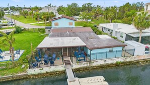 A house with a dock, outdoor seating, and a view of the water. - 6BR Waterfront • Direct Gulf • Fire Pit • Biliards (Hernando Beach)