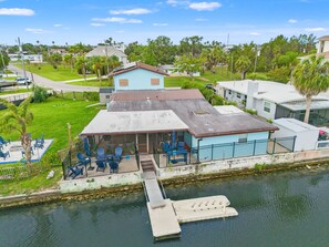 A house with a dock, outdoor seating, and a view of the water. - 6BR Waterfront • Direct Gulf • Fire Pit • Biliards (Hernando Beach)
