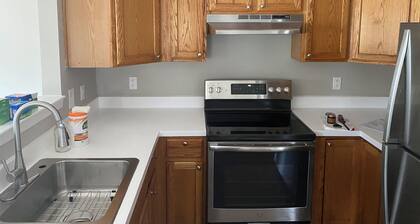 Fully furnished room in sun-drenched condo. 7 minute walk to Wheaton metro.