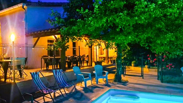 An outdoor pool area with lounge chairs and a dining area under a tree. - Gorgeous home in Balazuc with private swimming pool, can be inside or outside (Balazuc)