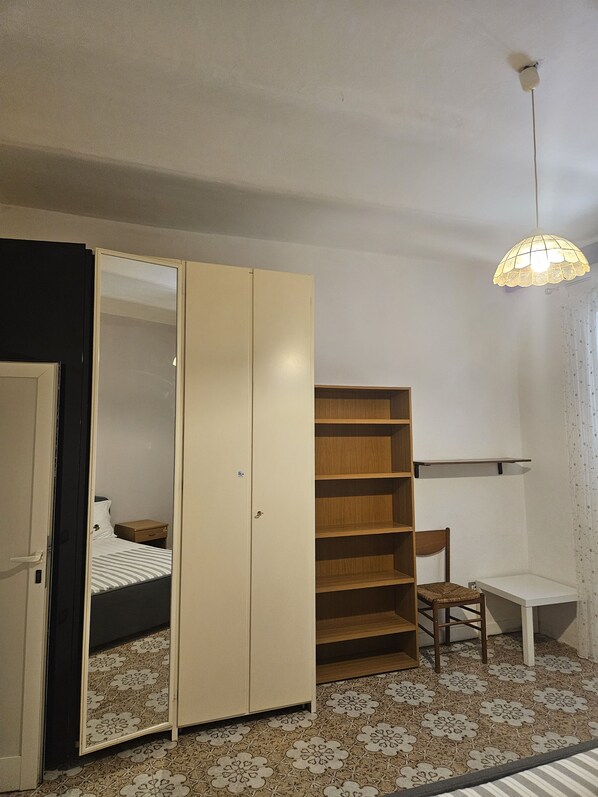 A bedroom with a bed, a wardrobe, a desk, and a chair. - MAGICAL ROME, just 10 minutes from Termini (Roma)