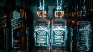 A refrigerated display case with bottles of Jack Daniel's Tennessee Whiskey. - THEMED APARTMENT "50 Shades of .....". (Torrox-Costa)