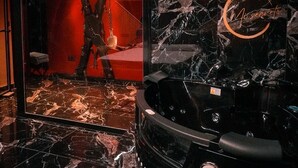 A spa area with a black marble floor, a hot tub, and a red-lit room with a large mirror. - THEMED APARTMENT "50 Shades of .....". (Torrox-Costa)