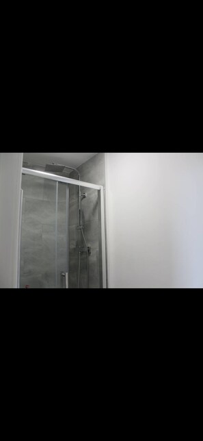 Shower, hair dryer, slippers, towels