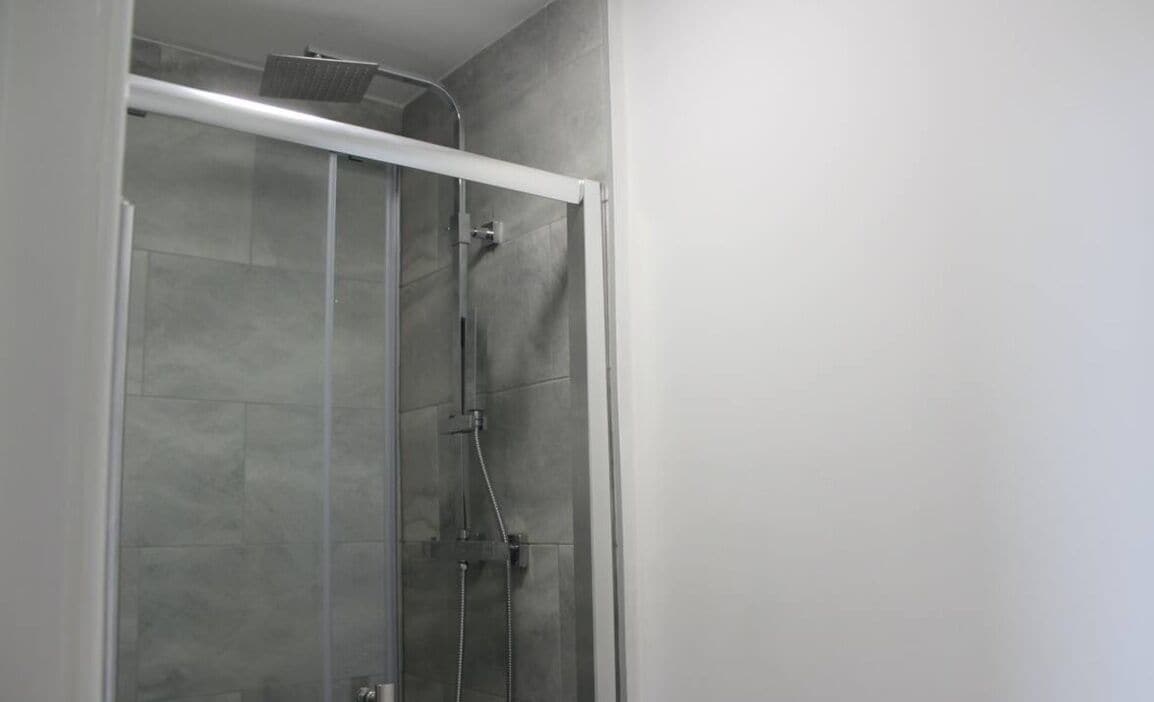 Shower, hair dryer, slippers, towels