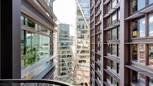 A modern high-rise building with multiple floors, large windows, and a glass facade. - Blueground | Shoreditch, pool, nr Barbican (London)