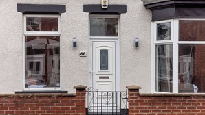 A house with a white front door, two windows, and a brick wall. - The Royal Residence - Sorley Steet, 2 minutes to Royal Sunderland Hospital (sunderland)