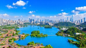 A cityscape with a river, green areas, and modern buildings. - Changsha Marriott Hotel West (Changsha)