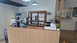 A bakery counter with a wooden display case, a coffee machine, and a 'TIP BOX' sign. - h&Y chaweng (Koh Samui)