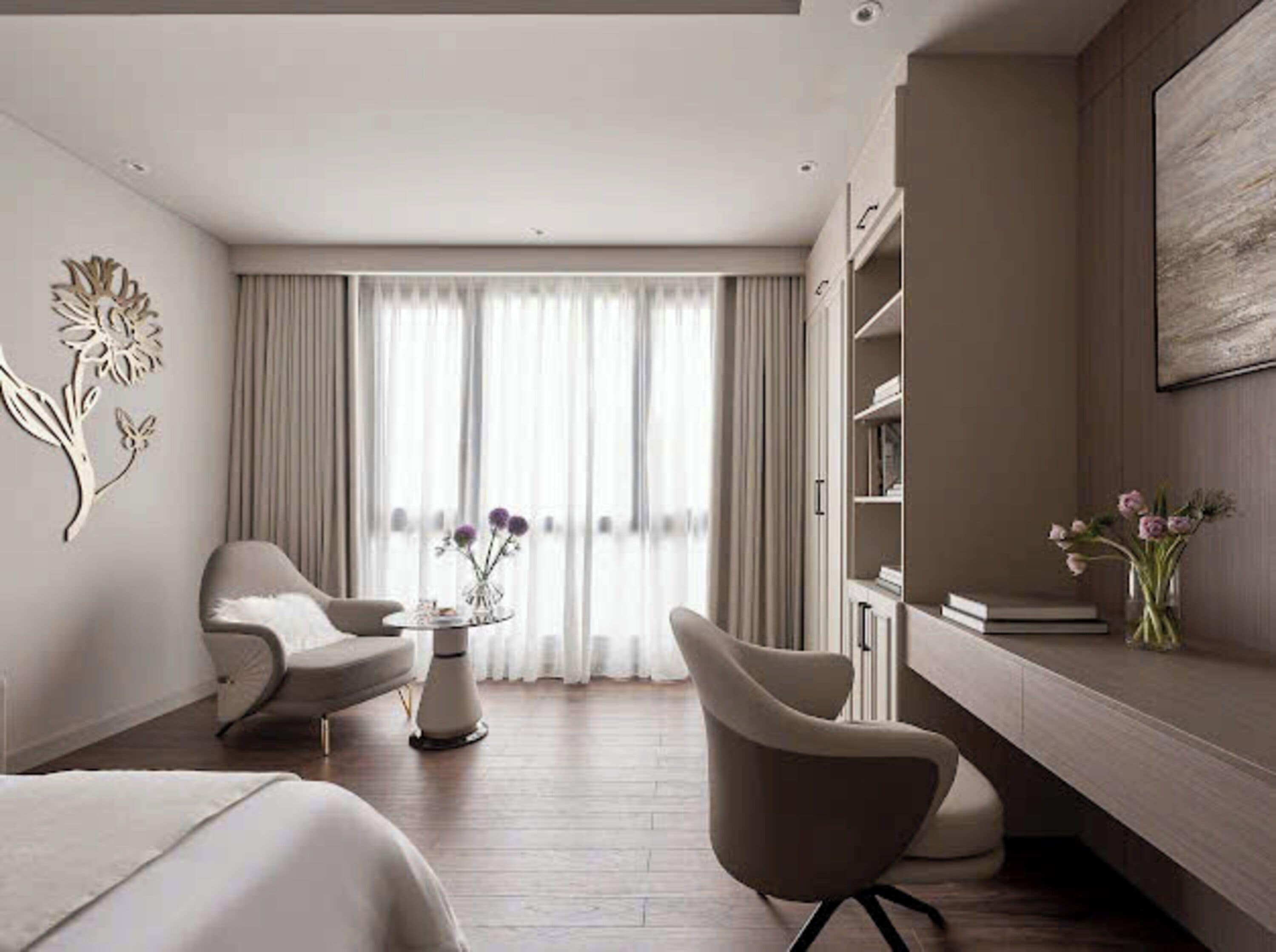 A modern hotel room with a large window, a desk with a chair, a bookshelf, and a decorative wall piece.