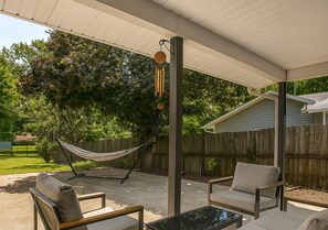 Relax outdoors on the private patio with cozy seating and a hammock—perfect for unwinding after a long day. - Family Home: Game Room & Huge Yard, Airport (Maryland Heights)