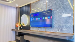 A modern reception desk with a flat-screen TV displaying various streaming services. - Bien Sao Hotel Duong Quang Ham (Ho Chi Minh City)