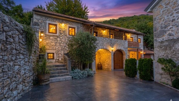A stone building with a courtyard, arched entrance, and multiple windows. - Villa Mariva residence Crikvenica by Villas Guide (Tribalj)