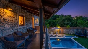A stone exterior with outdoor seating and a swimming pool. - Villa Mariva residence Crikvenica by Villas Guide (Tribalj)