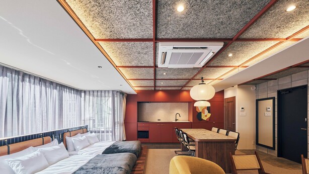 A hotel room with a bed, sofa, dining table, chairs, and a kitchen area. - illi Jam Shinsaibashi (Osaka)