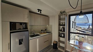 A modern kitchen with a built-in refrigerator, a sink, and a window overlooking a scenic view. - Paradise view Bariloche (San Carlos de Bariloche)