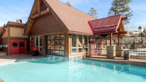A building with a swimming pool, large windows, and a red door. - Ski-In/Out Luxury•1 Blk to Main•Pool+Hot Tub•Sauna (Breckenridge)