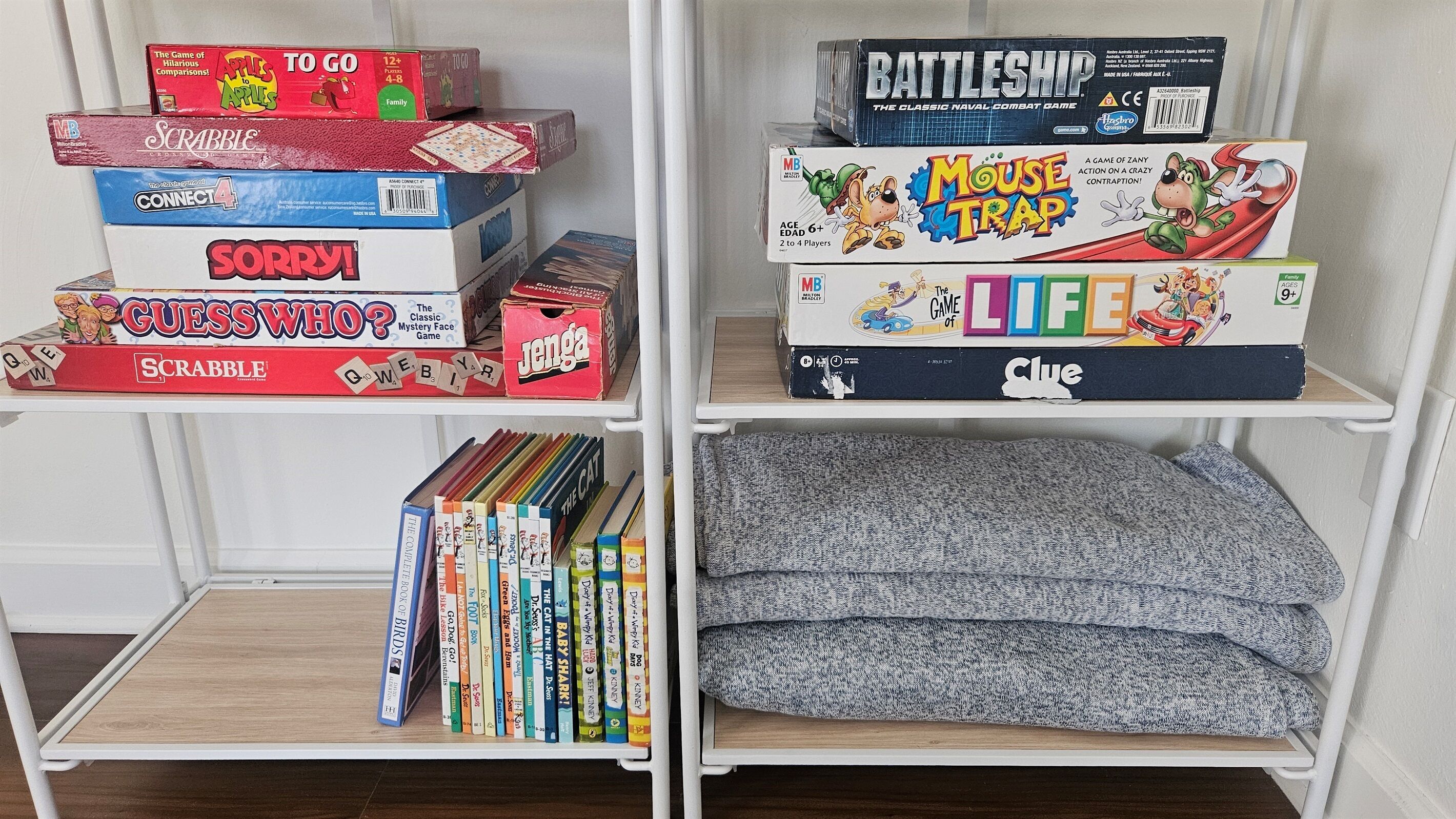Une bibliothèque contenant divers jeux de société et livres.