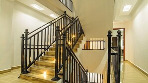 A multi-level staircase with black railings and wooden steps. - Grand Tiara Hotel Naivasha (Naivasha)