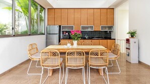 Une cuisine moderne avec des meubles en bois, un réfrigérateur en acier inoxydable et un four à micro-ondes.