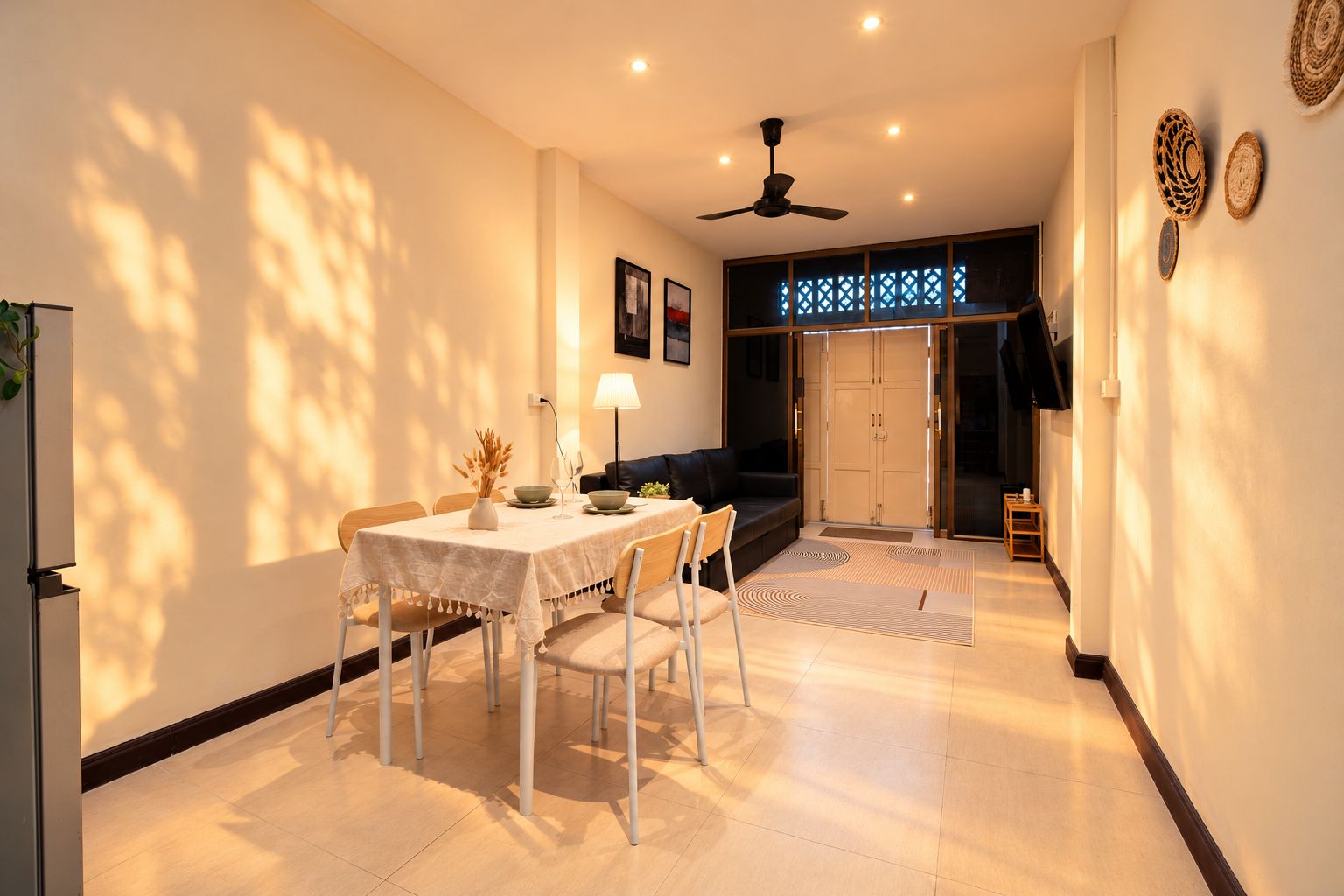 A dining area with a table, chairs, and a ceiling fan.