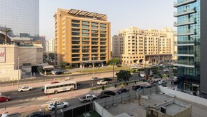 A multi-story building with a modern architectural design, featuring a mix of glass and concrete facades.