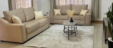 Deluxe Apartment, Garden View | Living area | 32-inch Smart TV with digital channels