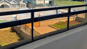 A residential building with a modern design, featuring a flat roof and a water tank on the roof. - Lux Suites The comfort Place Naivasha (Naivasha)