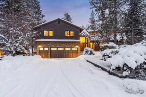 A two-story house with a stone foundation and a garage. - Sleeps 14+ | 7 bed, 6 bath | SHARC | EV | Peloton (Sunriver)