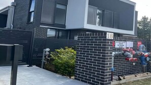 A modern two-story building with a brick facade and a number '18' sign. - Luxury Private Room For Rent (Sydney)