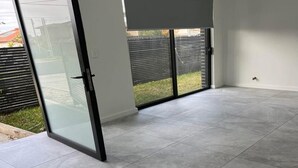 A room with a sliding glass door leading to a patio area. - Luxury Private Room For Rent (Sydney)