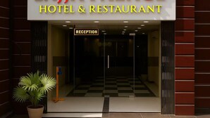 The entrance to Lajja Palace Hotel & Restaurant with a reception area visible through the glass doors. - Hotel Lajja Palace (Haridwar)