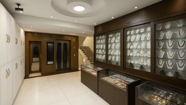A modern interior with a central staircase, a display of jewelry cases, and a reception area. - Hotel Lajja Palace (Haridwar)