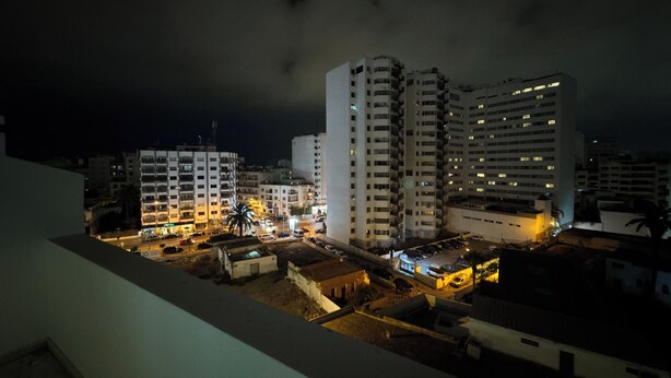A nighttime view of a cityscape with high-rise buildings, illuminated windows, and a clear sky. - 3-Bedroom Apartment with Panoramic Rooftop Terrace — Gauthier, Casablanca (Casablanca)