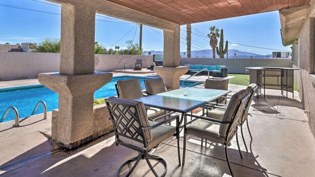 A covered outdoor area with a pool, seating, and a view of mountains. - Putting Green & Pool Table: Lake Havasu City Gem! (Lake Havasu City)