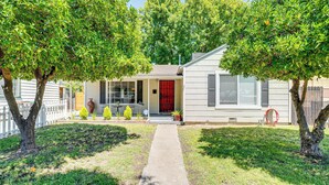 A single-story house with a red door, a front porch, and a pathway leading to the entrance. - < 1 Mi to Oakland A's Park: West Sacramento Home (West Sacramento)