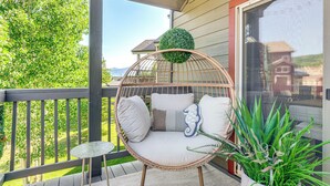 A wicker chair with cushions on a balcony, a small round table, and a potted plant. - 8 Mi to Copper Mtn: Frisco Home w/ Shuttle Access (Frisco)