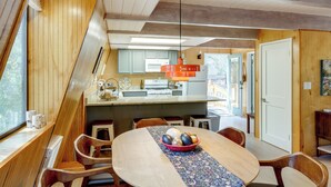 A modern kitchen with wooden cabinetry and a central island. - Walk to Village: Cozy Cabin in Pine Mountain Club! (Pine Mountain Club)