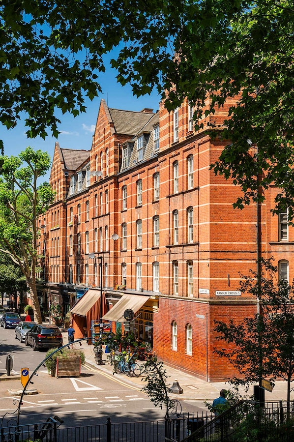 A red brick building with multiple windows and a corner entrance.