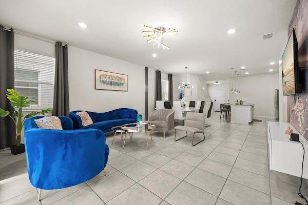 This open-concept living area is designed for comfort and connection, with plush seating and direct access to the private patio and pool.