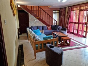 Family Bungalow, Garden View | Living area | 32-inch Smart TV with digital channels