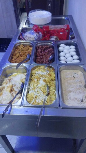 A buffet with various food items including rice, beans, eggs, and other dishes. - AL AHRAR HOTEL (Dubai)