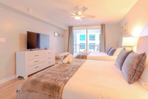 A hotel room with a bed, a TV, a desk, and a balcony with a view. - Grand 1BR | Free Parking | Near Bayfront Park (Miami)