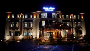 A hotel with a prominent sign reading "Green Village Hotel & Spa". - Green Village Hotel and Spa  (Samaxi)